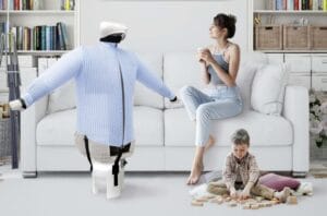 donna seduta sul divano con bambino che gioca e manichino stira-camicie