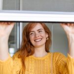 donna che apre una zanzariera