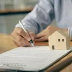 uomo che firma documento